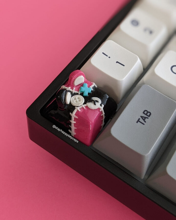 Punk goth teddy bear keycap on a mechanical keyboard.