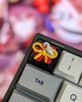 Genshin Impact keycap on the esc key with Hu Tao in the background.