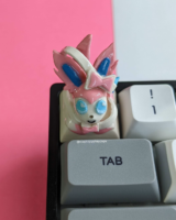 Sylveon artisan keycap on a mechanical keyboard with a red background shot with a front view.