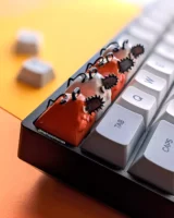 White and orange Pochita keycaps on a 60% mechanical keyboard.
